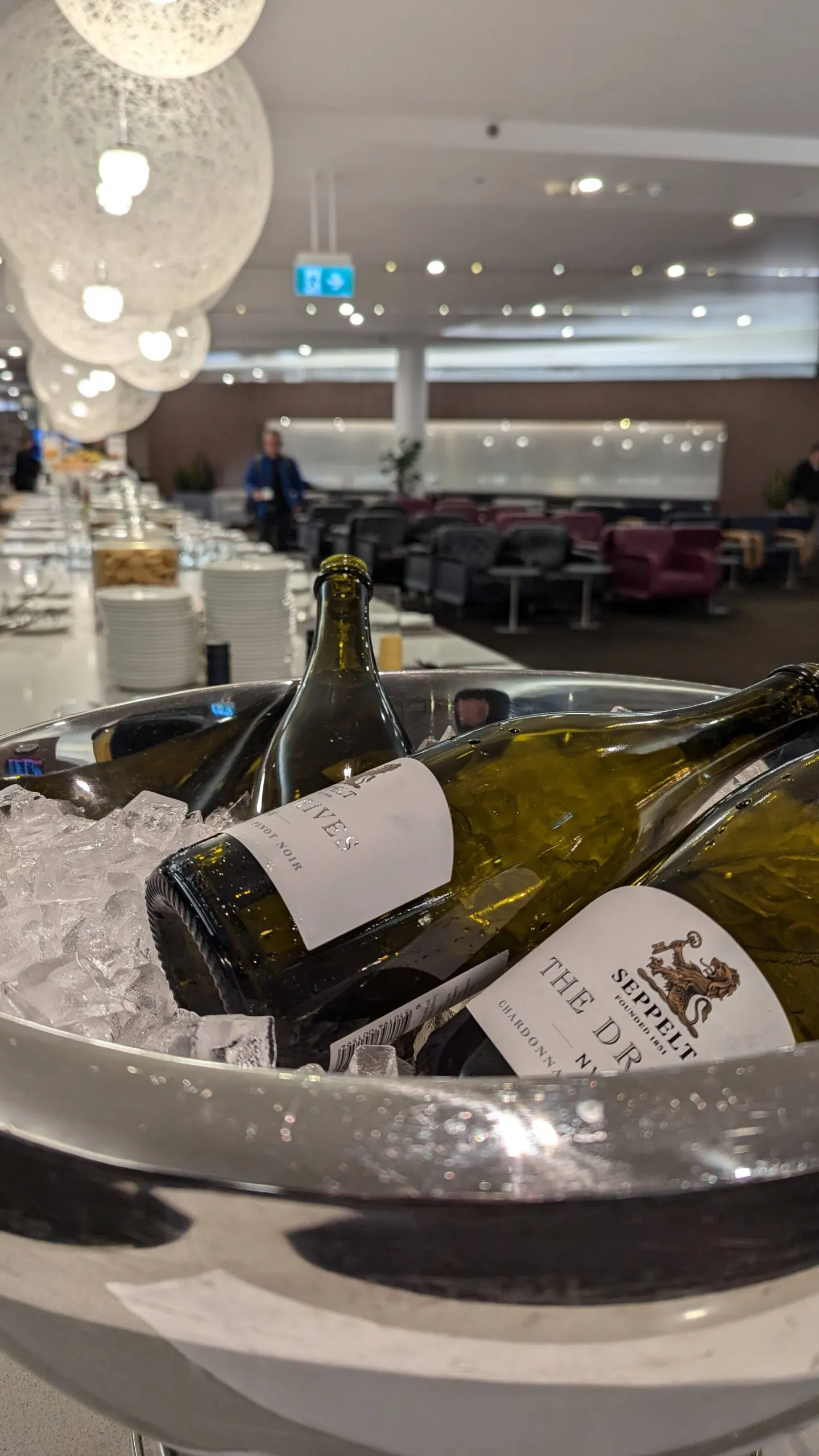 A glass of wine in a Qantas lounge